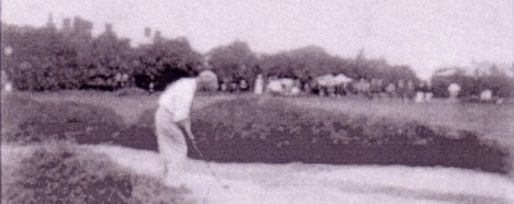 A vintage golf photo of JJ McDermott playing from a bunker on the final hole of the US Open 1912.