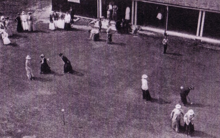 A photo of women golfers on a putting green circa 1910.